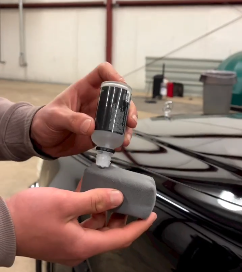 Ceramic coating being applied under shop lights